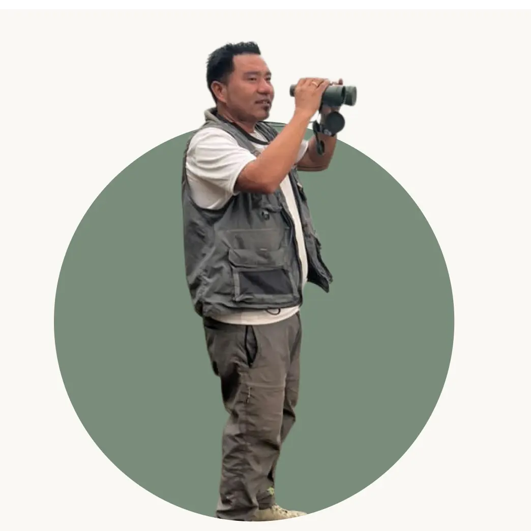 Founder L Drukpa scanning the horizon with binoculars